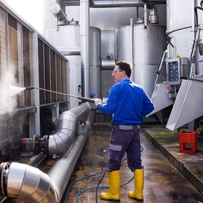 worker cleaning with a washer in a site